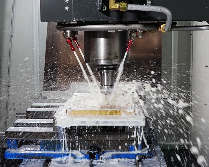 CNC machining of a precision metal component with coolant CNC machining of a precision metal component with coolant